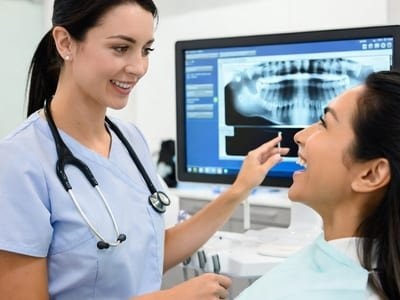 Dental team member reviewing an x-ray with a patient