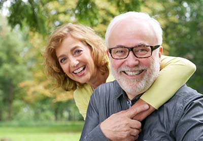 couple smiling after restorative dentistry appointment