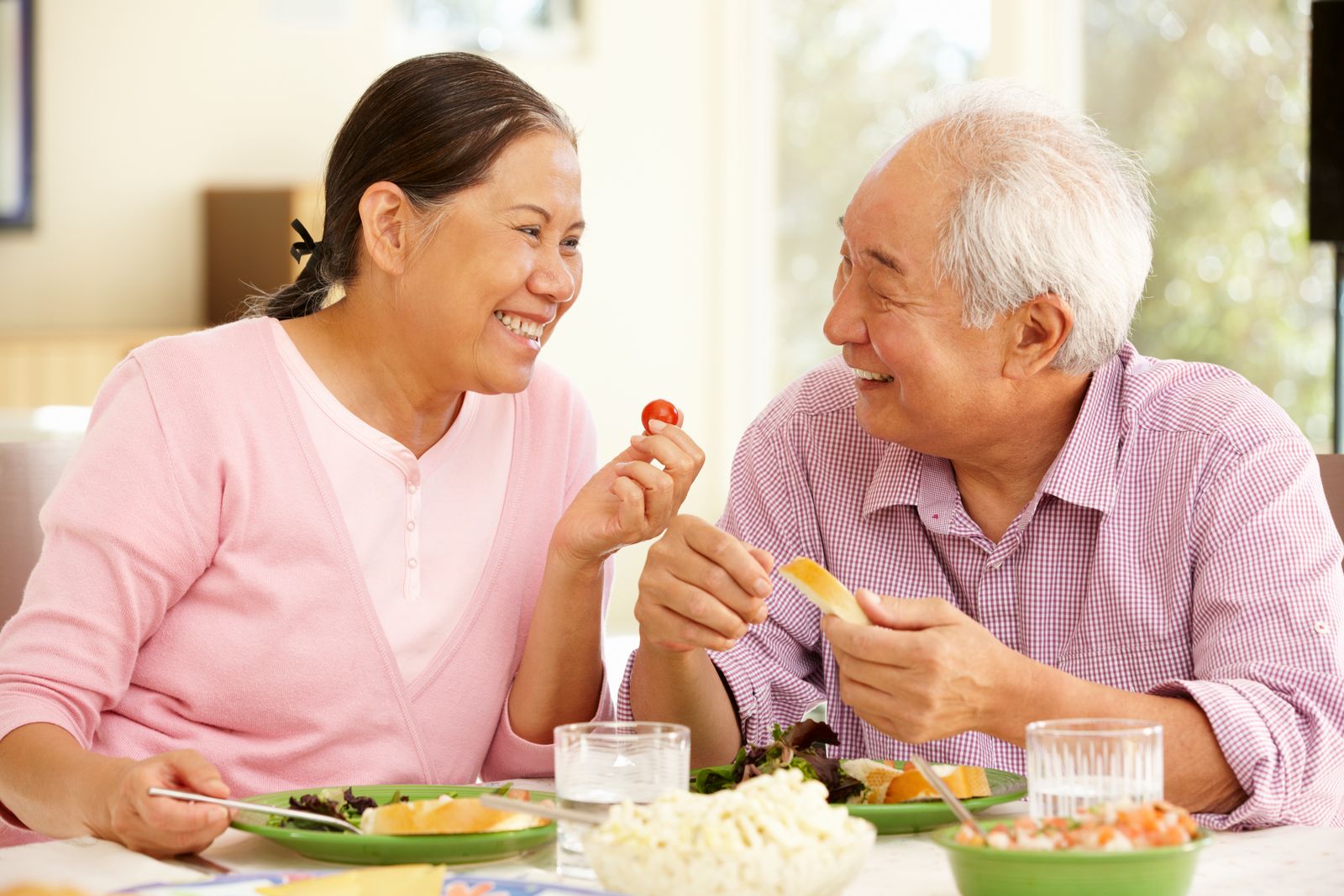 man with dental implants smiling with his wife